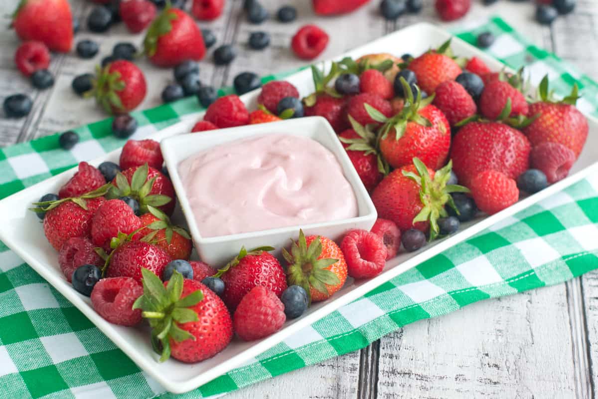 Very Berry Cheesecake Dip on platter with fresh berries. 