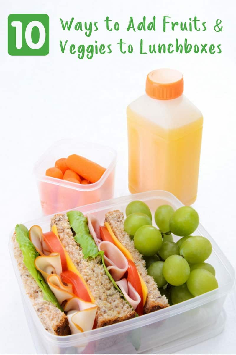 Lunchbox with sandwich, grapes, carrots and juice on white background