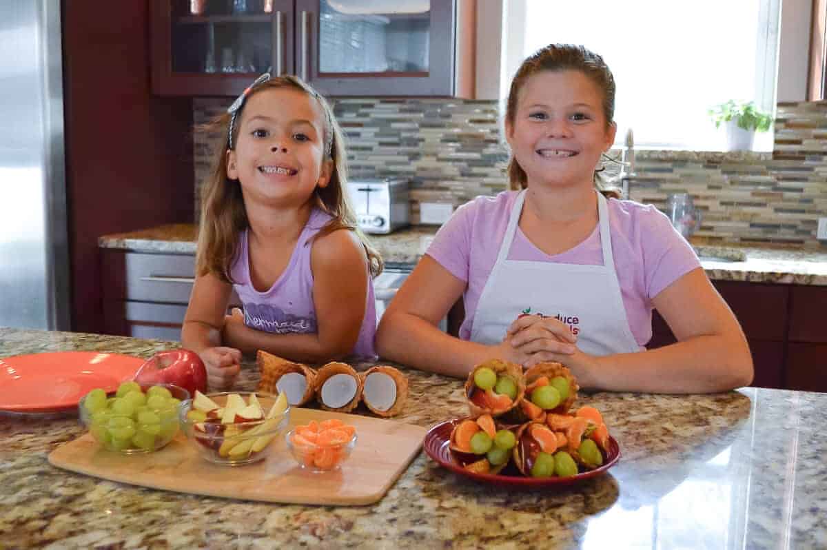 the kids making fruit cornucopias