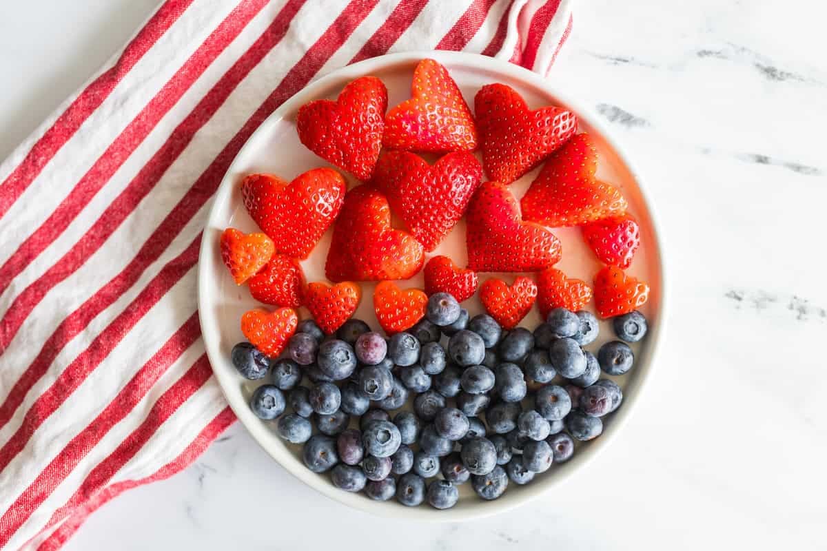 how to make Strawberry Valentine's Day Skewers Strawberries and blueberries on a plate.
