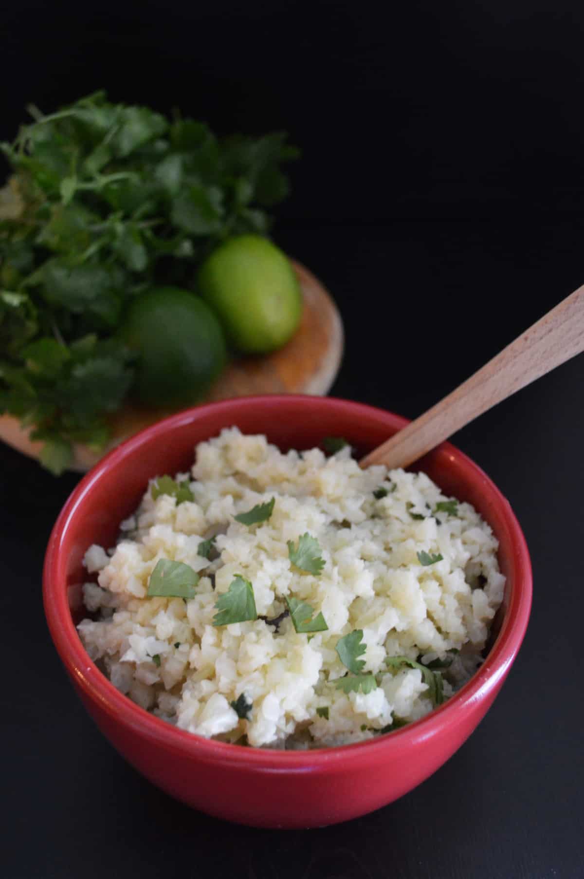Cilantro and lime cauliflower rice in bowl with spoon. 