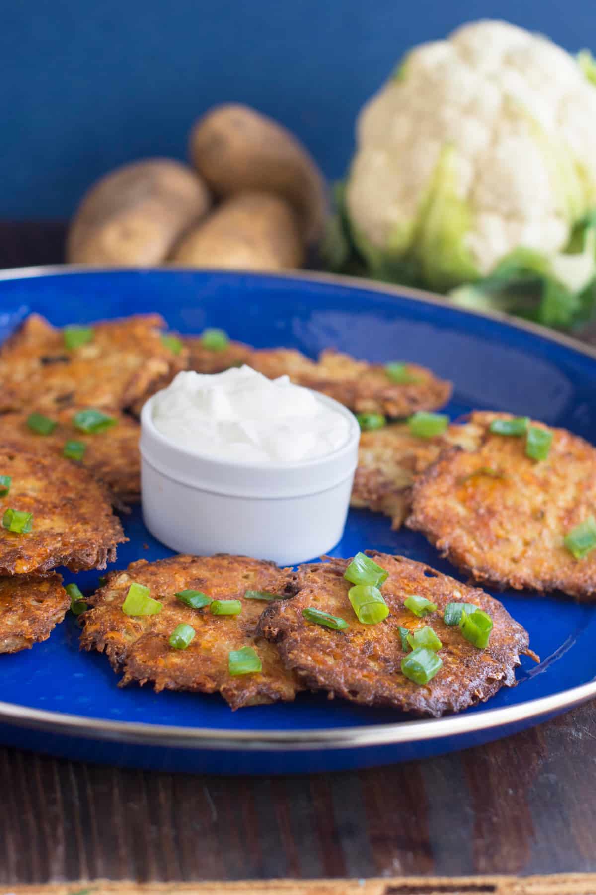 Baked Cauliflower and Cheese Latkes on blue plate
