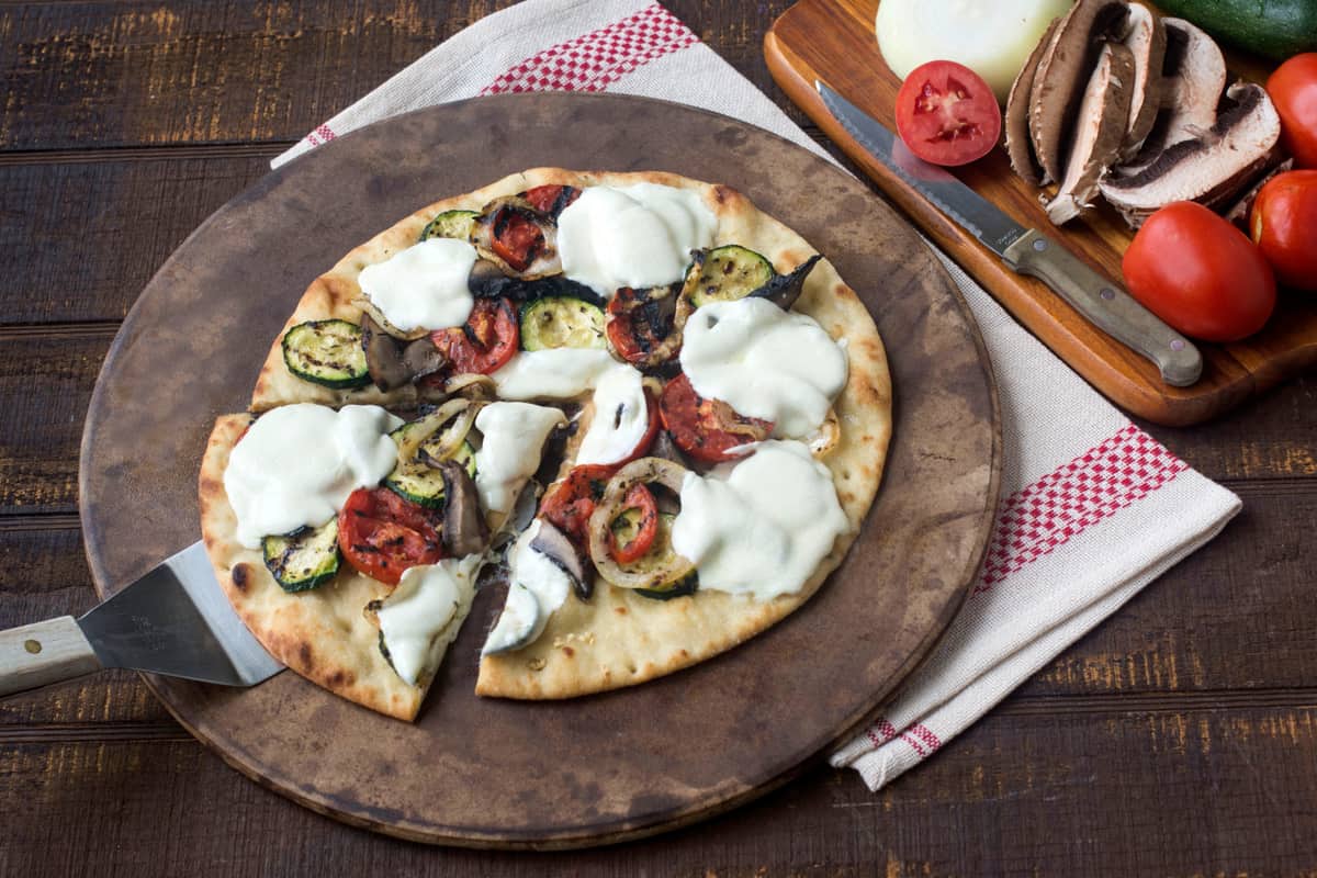 Grilled Summer Vegetable Pizza on pizza stone. 