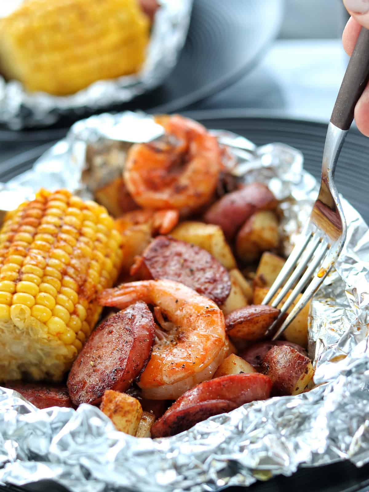 Enjoy the flavors of a traditional shrimp boil in these easy foil packets filled with shrimp, sausage, potatoes, corn, and Cajun seasoning.