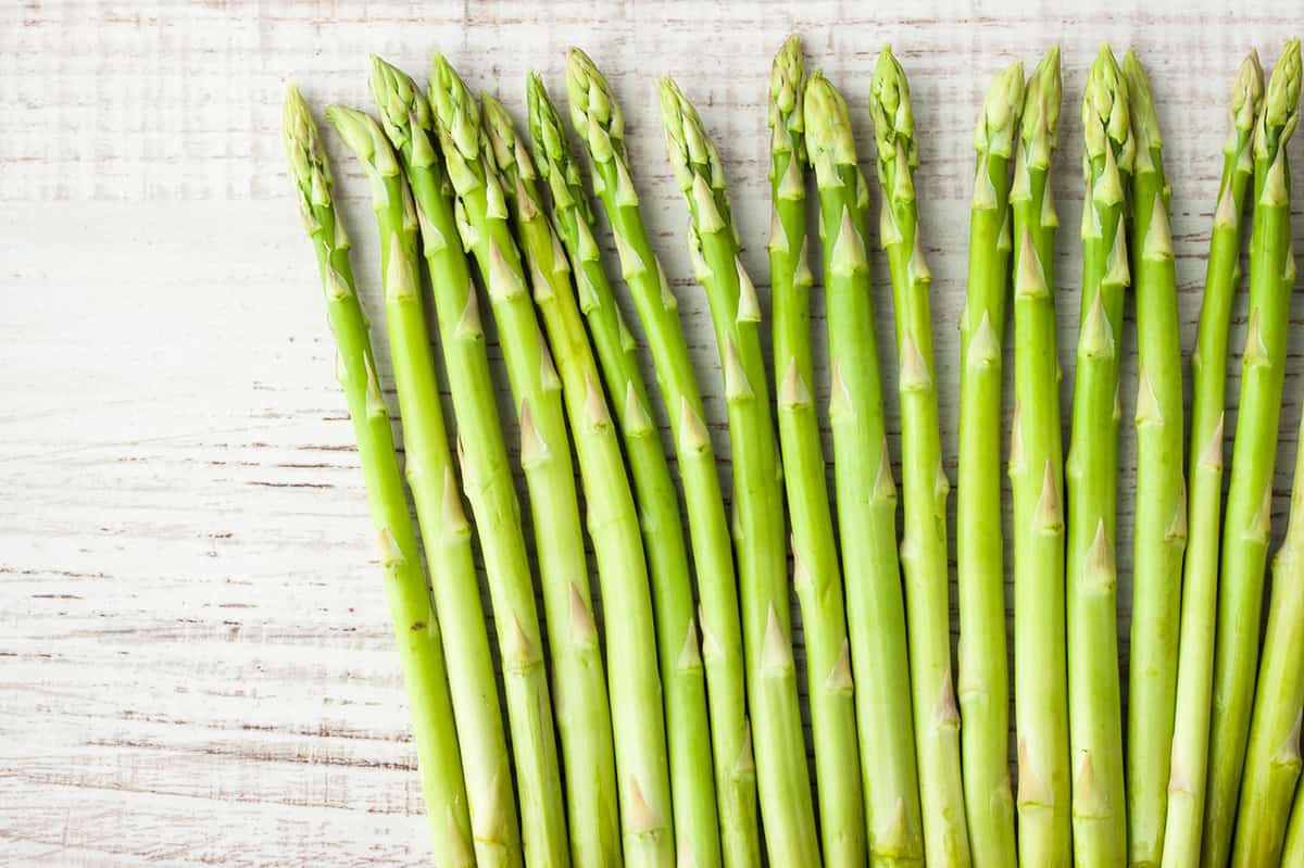 Sprigs of asparagus on the white table