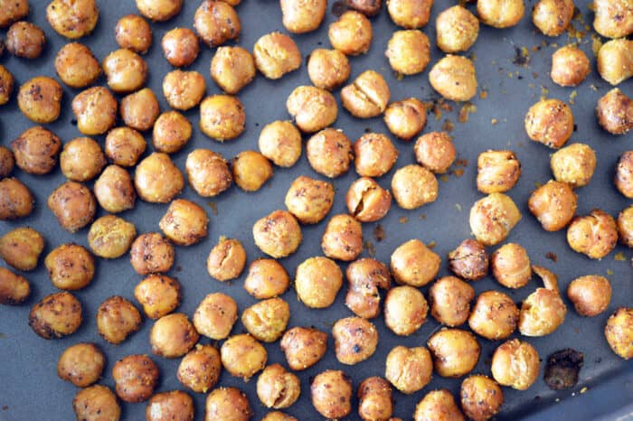 Close up of roasted chickpeas on baking sheet