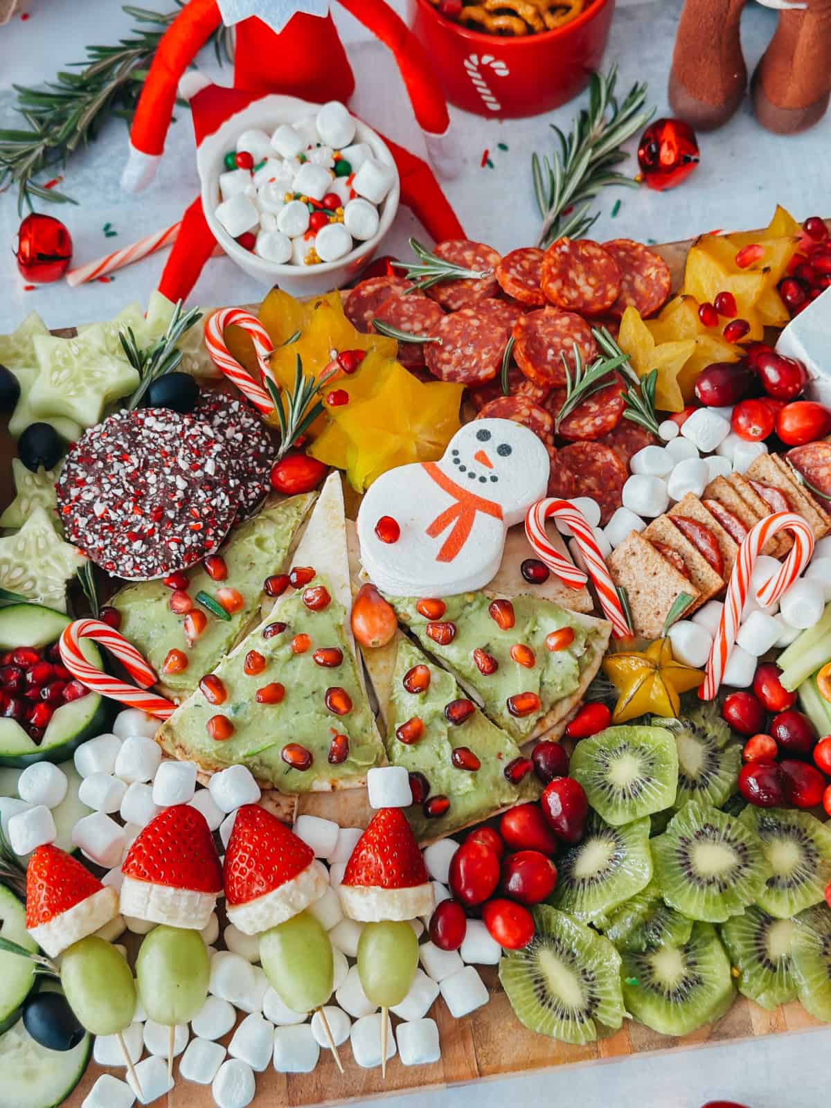 holiday charcuterie board with elf on the shelf