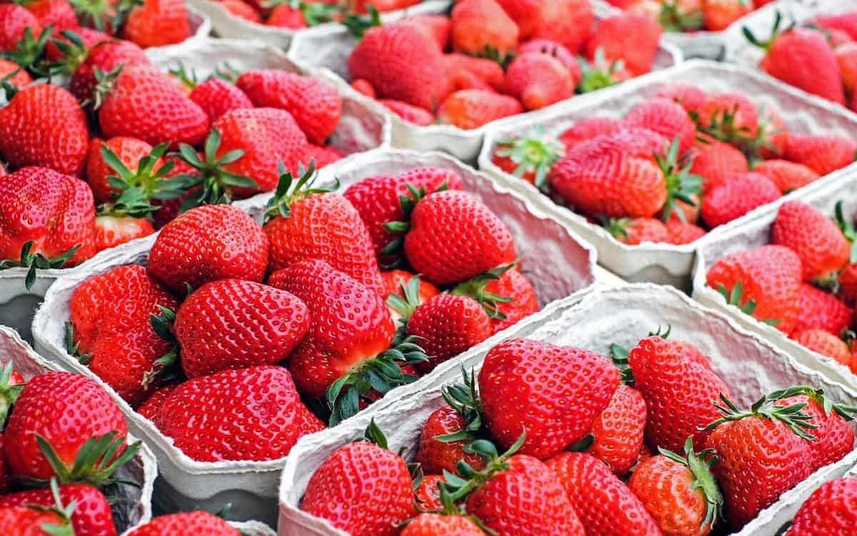 Strawberries in containers at stores.