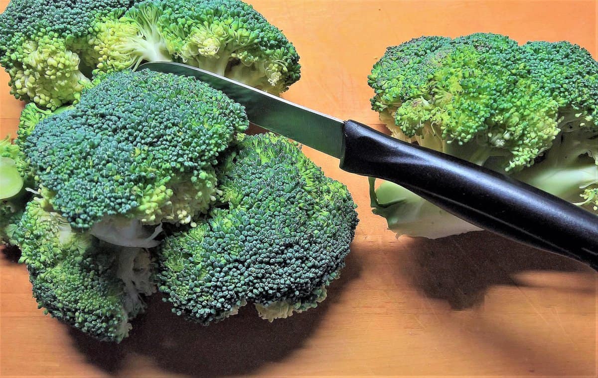 Thai Peanut Chicken and Vegetable Noodle Stir-Fry  Broccoli with Knife on Cutting Board