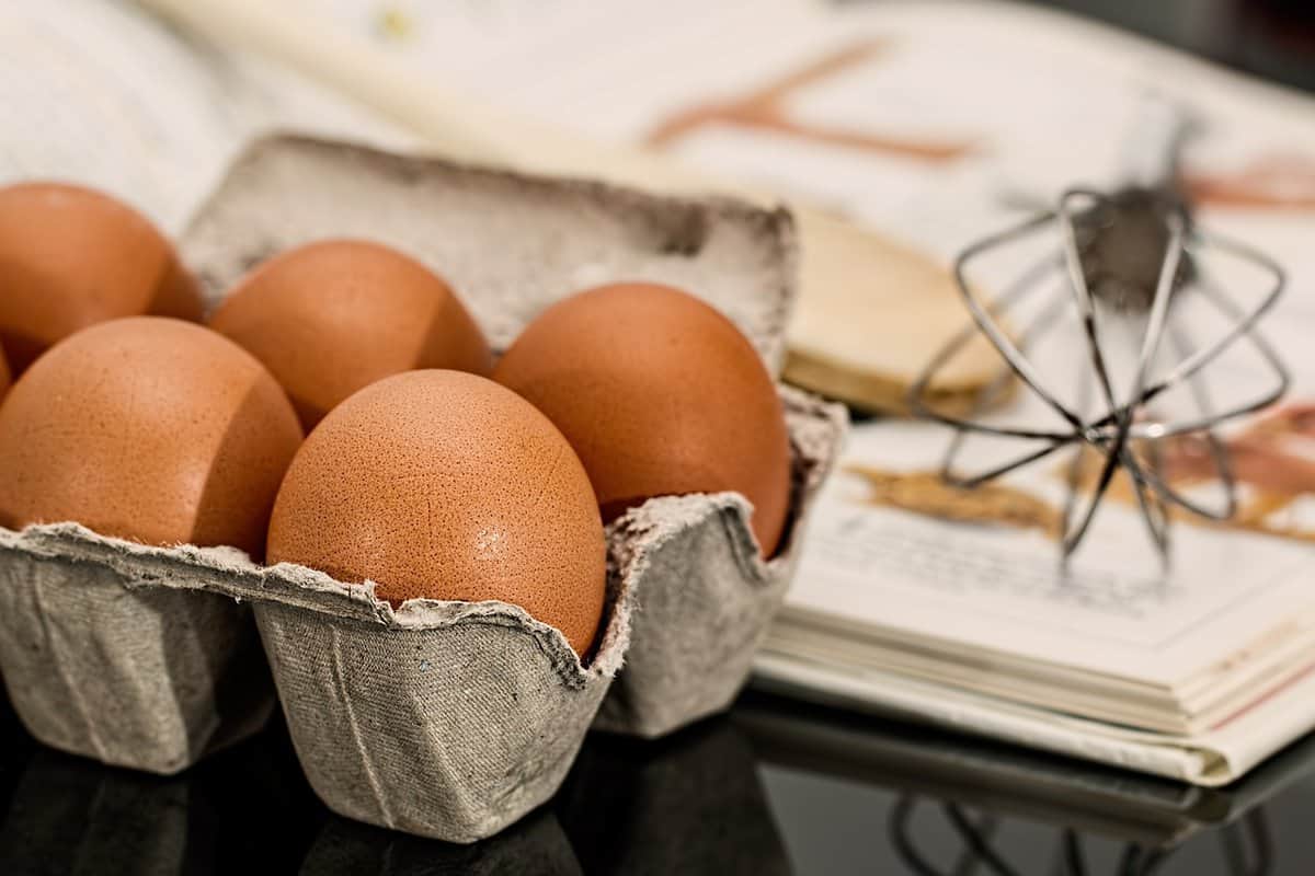 Greek Breakfast Casserole-Eggs in Carton Next to Whisk
