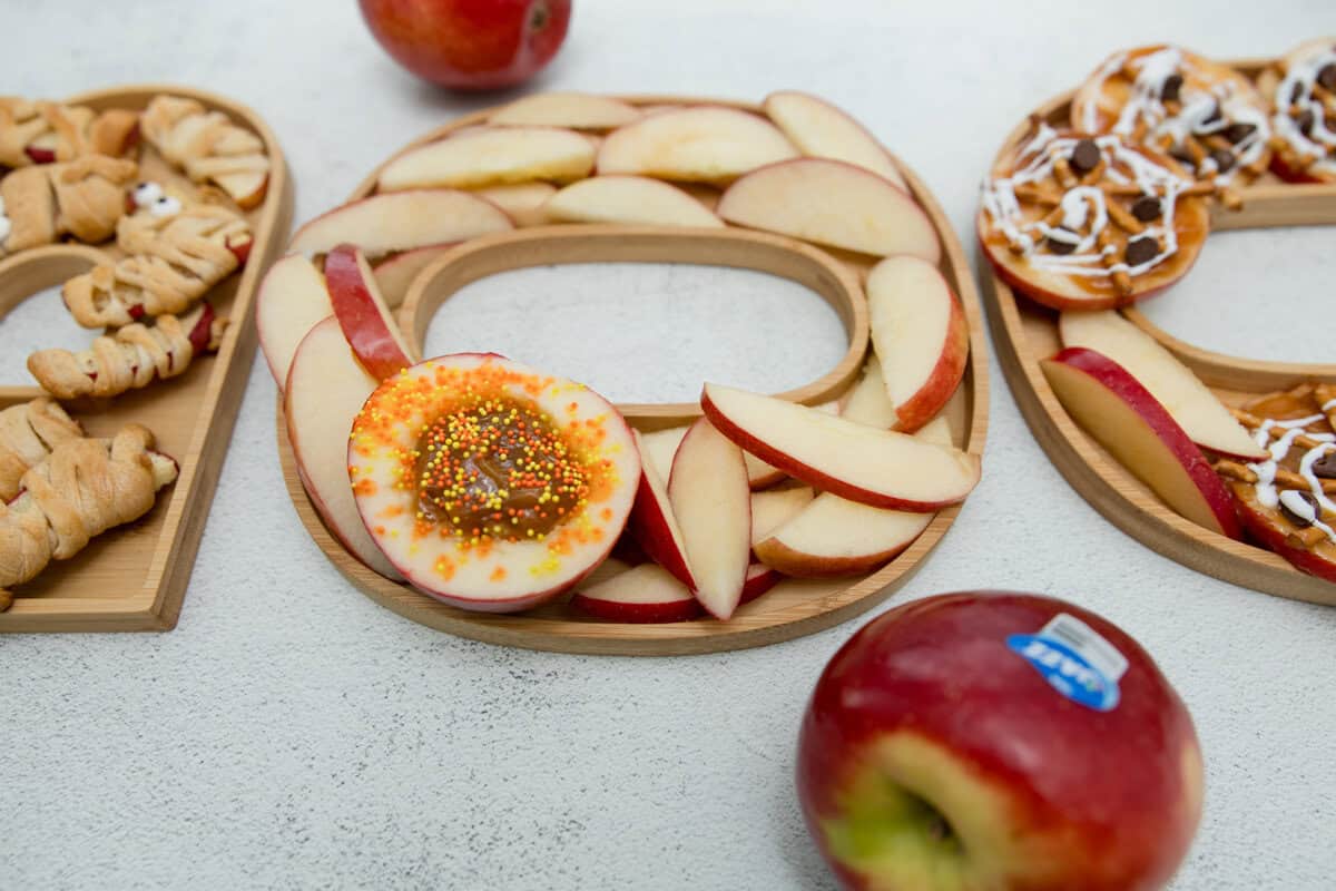 Sliced apples and a half apple filled with caramel.