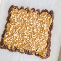 Date Bark preparation sheet with peanut butter and peanuts