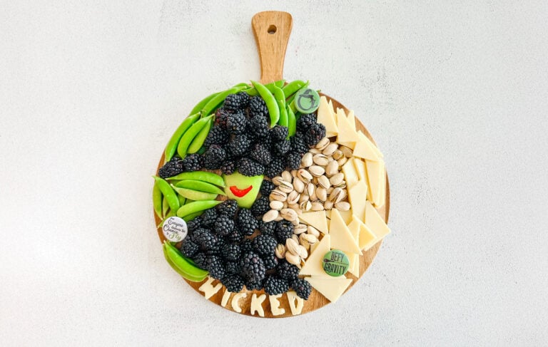 Wicked charcuterie board with cheese, pistachios, and blackberries