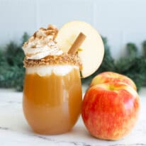 Apple cider mocktail decorated with cinnamon and apple