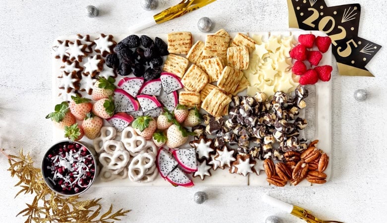 Sweet snack board with New Year's decorations.