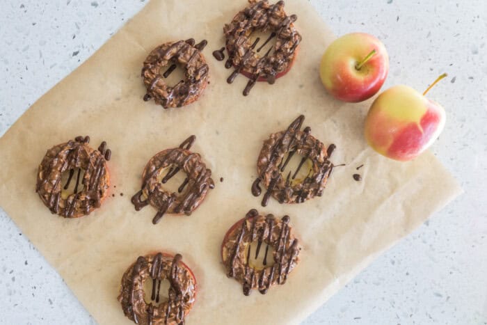 Apple samoas are prepared with toppings as a healthy snack choice.