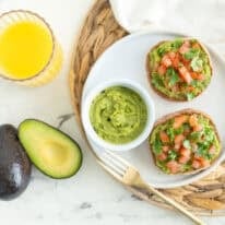 Easy avocado breakfast ideas with guacamole English muffins topped with tomato and cilantro